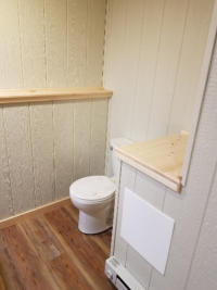 bathroom with paneling in walls and new laminate flooring