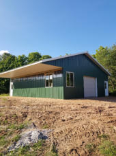 shed with green metal siding