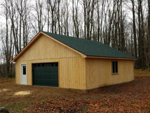shed in woods with wood siding