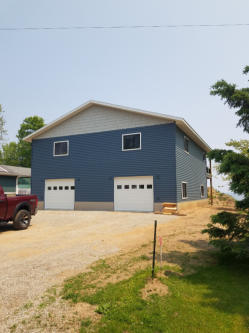 two car garage on back of house with blue siding