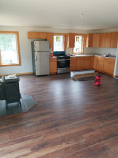 empty new home with kichen and wood stove