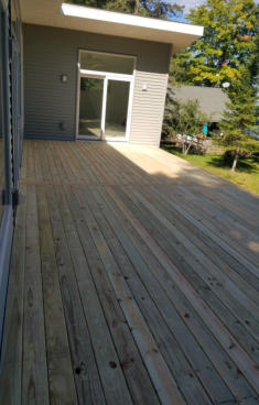 wooden deck on house with sliding doors