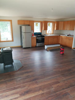 open concept living and dining room with laminate flooring