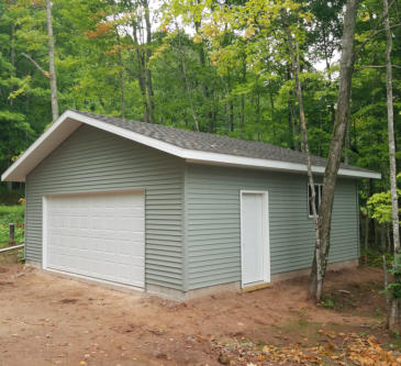 two car garage with light green siding