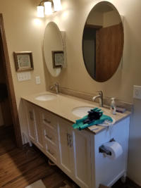two sink bathroom with circle mirrors